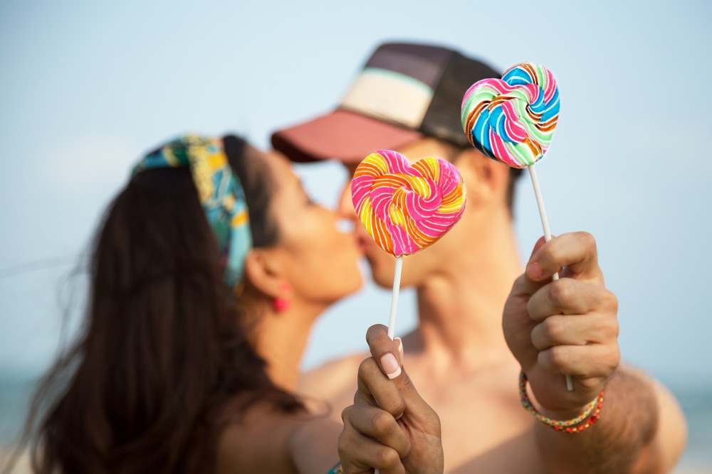 Summer kiss. Hand with Lollipop.